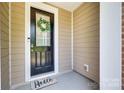 Front door of the home with a wreath and 'Hello' doormat at 12024 John Newton Dr, Davidson, NC 28036