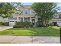 Home with a well-maintained front lawn, green shrubs, an inviting front door, and a two-car garage at 133 Yellowbell Rd, Mooresville, NC 28117