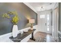 Stylish entryway featuring a wooden console table, decorative lamp, vase, and views of the front door at 1432 Ardmore Dr # 341, Sherrills Ford, NC 28673