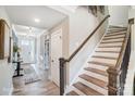 Bright hallway with stairs, wood floors, decorative doors, and an entryway visible at the end of the hall at 1432 Ardmore Dr # 341, Sherrills Ford, NC 28673