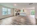 Spacious living room with modern flooring, lots of light, and an open layout to the kitchen at 1543 Cottage Creek Dr, Bessemer City, NC 28016