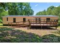Back of home featuring a large deck with ramp and french doors leading into home at 1773 Baldwin Ln, Lincolnton, NC 28092
