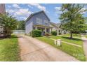 A well-maintained home is showcased with its lush green lawn and concrete driveway at 1825 Stroud Park Ct, Charlotte, NC 28206