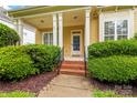 Charming front porch with white pillars and brick steps leading to the entrance at 187 Water Oak Dr, Mooresville, NC 28117