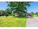 Charming brick home with large front yard and attached carport on a sunny day at 2309 13Th Street Ne Dr, Hickory, NC 28601