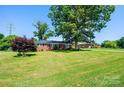 Beautiful brick home featuring a well-manicured lawn and mature shade trees at 2309 13Th Street Ne Dr, Hickory, NC 28601