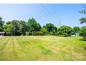 Expansive green lawn with mature trees offering shade on a sunny day at 2309 13Th Street Ne Dr, Hickory, NC 28601