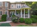 Home's cozy front porch with gazebo, white columns, and lush greenery welcomes visitors at 2541 Penngate Dr, Sherrills Ford, NC 28673