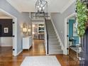 Inviting foyer with hardwood floors, staircase, and stylish decor, setting an elegant tone at 314 Southern Cross Ln, Matthews, NC 28105
