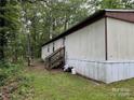 Rear exterior view of manufactured home with wooden stairs to enter the home at 326 Havencrest Ct, Gastonia, NC 28052