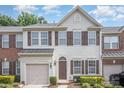 Charming townhome exterior with neutral siding, brown shutters, and a one-car garage at 3326 Park South Station Blvd, Charlotte, NC 28210
