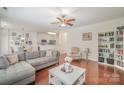 Spacious living room with hardwood floors, ceiling fan, and view into the kitchen and dining areas at 3326 Park South Station Blvd, Charlotte, NC 28210