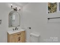 This bathroom features a modern vanity, a mirror, and contemporary fixtures at 4315 Gibbon Rd, Charlotte, NC 28269