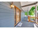 Charming front porch features craftsman wood door, exterior lights, stone columns and lake view at 4681 Dove Point Ln, York, SC 29745