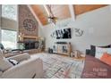 Inviting living room with brick fireplace, vaulted ceilings, wood beams and stylish decor at 4681 Dove Point Ln, York, SC 29745