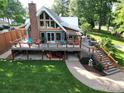 Stunning lake house featuring a large back deck, outdoor kitchen, beautifully landscaped yard, and brick chimney at 4681 Dove Point Ln, York, SC 29745