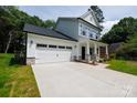 Charming two-story home with a two car garage, stone accents, and a well manicured front lawn at 512 Beverly Cir, Charlotte, NC 28270