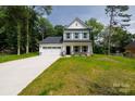Charming two-story home with a two car garage, stone accents, and a well manicured front lawn at 512 Beverly Cir, Charlotte, NC 28270