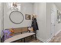 Stylish entryway with a bench, round mirror, and decor for a welcoming first impression at 524 Tayberry Ln, Fort Mill, SC 29715