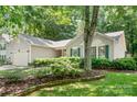 Beautiful single-story home with well-maintained landscaping, healthy bushes, and a lush green lawn at 5400 Groveton Ct, Charlotte, NC 28269