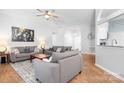 Spacious living room with wood flooring and neutral paint, offering ample seating and a seamless open layout at 5400 Groveton Ct, Charlotte, NC 28269