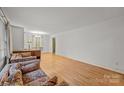 Bright living room with hardwood floors, neutral walls, and ample natural light from large windows at 6207 Robinson Church Rd, Charlotte, NC 28215