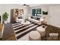 Bright living room with modern furniture, a stylish rug, and plenty of natural light from large windows at 6208 Charlie Walker Rd, Kannapolis, NC 28081