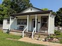 Charming home with a covered front porch, benches, and landscaped garden at 714 E Dunlap St, Lancaster, SC 29720