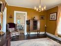 Elegant living room featuring vintage furnishings, chandelier, hardwood floors, and ample natural light at 714 E Dunlap St, Lancaster, SC 29720