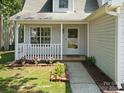 Charming front porch with decorative plants and a well-manicured lawn leading to the entrance at 8030 Glencannon Dr, Charlotte, NC 28227