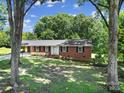 Charming brick home with mature trees providing shade and curb appeal at 967 Hilldale Dr, Lancaster, SC 29720