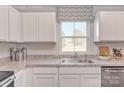 Bright kitchen featuring white cabinets, stainless steel appliances, and a granite countertop at 10127 Florentine Way, Charlotte, NC 28214