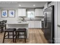Bright kitchen featuring stainless steel appliances, granite countertops, a breakfast bar and modern cabinetry at 10127 Florentine Way, Charlotte, NC 28214