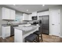 Bright kitchen featuring stainless steel appliances, granite countertops, a breakfast bar and modern cabinetry at 10127 Florentine Way, Charlotte, NC 28214