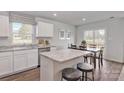 Open kitchen with island, granite countertops, stainless appliances, and a dining area at 10127 Florentine Way, Charlotte, NC 28214