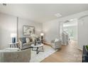 Bright living room featuring modern furniture and hardwood floors at 10225 Alexander Martin Ave, Charlotte, NC 28277