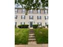 Inviting condo building entrance with lush greenery, enhancing the property's curb appeal and serene environment at 1104 Plaza Walk Dr, Charlotte, NC 28215