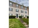 Attractive condo building showcasing a well-manicured lawn, a welcoming entryway, and elegant architectural details at 1104 Plaza Walk Dr, Charlotte, NC 28215