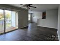 Bright living room with hardwood floors and sliding glass doors to the balcony, offering great natural light at 1104 Plaza Walk Dr, Charlotte, NC 28215