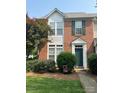 All brick townhome featuring green lawn and manicured front yard at 12378 Swan Wings Pl, Huntersville, NC 28078