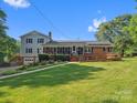 Charming home featuring a ramp for accessibility, complemented by lush landscaping and a well-manicured lawn at 1238 Carl Allen Rd, Edgemoor, SC 29712