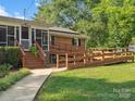 Exterior view featuring a wheelchair ramp for accessibility, leading to the screened porch entrance at 1238 Carl Allen Rd, Edgemoor, SC 29712
