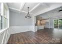 Elegant living room with hardwood floors, coffered ceiling, and open layout to the kitchen at 129 John Smith Rd, York, SC 29745