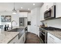 Modern kitchen featuring stainless steel appliances, granite countertops, and sleek fixtures at 1428 Winding Stream Rd, Charlotte, NC 28206