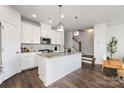 Bright kitchen with stainless steel appliances, center island, and sleek hardwood floors for a modern style at 1428 Winding Stream Rd, Charlotte, NC 28206