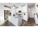 Stylish kitchen with stainless appliances, granite counters, central island, and white cabinets at 1428 Winding Stream Rd, Charlotte, NC 28206
