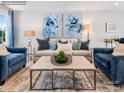 Stylishly furnished living room featuring plush seating, modern artwork, and a decorative coffee table at 1549 Cottage Creek Dr, Bessemer City, NC 28016