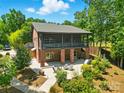 Spacious brick home featuring a screened-in porch and outdoor seating area, perfect for relaxation at 16525 Tulloch Rd, Charlotte, NC 28278
