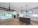 Open concept living room area with hardwood floors, fireplace and access to a large fenced-in backyard at 1724 Dallas Ave, Charlotte, NC 28205