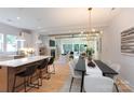 Open floor plan of kitchen and living room with island, white cabinets, fireplace, and lots of natural light at 1728 Dallas Ave, Charlotte, NC 28205